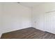 Well-lit bedroom with wood-look flooring and closet at 4344 Jaslo Ave, North Port, FL 34286