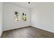 Well-lit bedroom with wood-look flooring and two large windows at 4344 Jaslo Ave, North Port, FL 34286