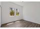 Bright bedroom with wood-look flooring and two windows at 4344 Jaslo Ave, North Port, FL 34286