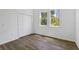 This bedroom features hardwood floors, closet space, and windows offering natural light at 4344 Jaslo Ave, North Port, FL 34286