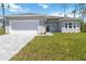 Charming single-story home with a well-manicured lawn and a paved driveway leading to a two-car garage at 4344 Jaslo Ave, North Port, FL 34286