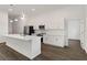 Modern kitchen featuring stainless steel appliances, white cabinets, and an island with pendant lighting at 4344 Jaslo Ave, North Port, FL 34286