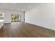 Bright living space with wood floors, white walls, and sliding glass doors to the backyard at 4344 Jaslo Ave, North Port, FL 34286