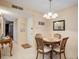 Cozy dining area with round table, chandelier, and neutral color palette at 219 S Mcmullen Booth Rd # 175, Clearwater, FL 33759