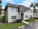 Charming condo featuring well-maintained landscaping, a palm tree and designated parking spaces at 219 S Mcmullen Booth Rd # 175, Clearwater, FL 33759