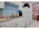 Efficient kitchen with white cabinets, white appliances and a stainless steel sink at 219 S Mcmullen Booth Rd # 175, Clearwater, FL 33759