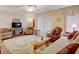 Cozy living room with ample seating, TV, ceiling fan and sliding door to patio, providing natural light at 219 S Mcmullen Booth Rd # 175, Clearwater, FL 33759