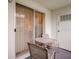 Enclosed patio featuring a glass sliding door with vertical blinds and outdoor seating at 219 S Mcmullen Booth Rd # 175, Clearwater, FL 33759