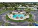 Aerial view of the sparkling pool with lounge seating and palm trees, nearby plenty of parking at 219 S Mcmullen Booth Rd # 175, Clearwater, FL 33759
