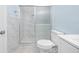 Modern bathroom featuring tiled shower with glass door, and white toilet at 3728 19Th E St, Bradenton, FL 34208