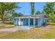 Charming blue single-story home with a covered patio, gravel, and green grass under a clear blue sky at 3728 19Th E St, Bradenton, FL 34208