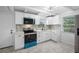 Updated kitchen showcasing white cabinets, stylish backsplash, and a black and blue range with quartz countertops at 3728 19Th E St, Bradenton, FL 34208