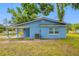 Rear exterior showcasing the home's blue siding, white window frames, and a view of the covered front porch at 3728 19Th E St, Bradenton, FL 34208
