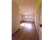 Comfortable bedroom featuring hardwood floors and a window for natural light at 10336 Oak Hill Dr, Port Richey, FL 34668