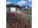 View of home with an attached garage and long driveway at 10336 Oak Hill Dr, Port Richey, FL 34668