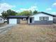Charming single-story home featuring a garage and well-lit entry at 10336 Oak Hill Dr, Port Richey, FL 34668