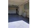 Spacious garage with epoxy flooring, shelving and ample room for parking and storage at 10336 Oak Hill Dr, Port Richey, FL 34668
