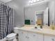Bathroom with modern vanity and hardware and a tub and shower combo with a black and white shower curtain at 18001 Richmond Place Dr # 126, Tampa, FL 33647