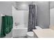 Bathroom featuring a toilet, a shower and tub combo with a stylish shower curtain, and a vanity with sink and hardware at 18001 Richmond Place Dr # 126, Tampa, FL 33647