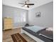 Bright bedroom with hardwood floors, a ceiling fan, and a large window allowing for natural light to illuminate the room at 18001 Richmond Place Dr # 126, Tampa, FL 33647