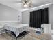 Comfortable bedroom featuring hardwood floors, a ceiling fan, and a large window to offer natural light at 18001 Richmond Place Dr # 126, Tampa, FL 33647