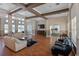 Bright clubhouse with hardwood floors, neutral walls, stylish furniture, TV, and an open doorway to the kitchen at 18001 Richmond Place Dr # 126, Tampa, FL 33647