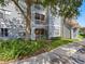 Charming condo exterior featuring multiple balconies, beautiful landscaping, and a well-maintained facade in a serene setting at 18001 Richmond Place Dr # 126, Tampa, FL 33647