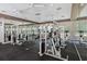 Spacious gym featuring modern equipment, large mirrors, multiple ceiling fans and natural light through the windows at 18001 Richmond Place Dr # 126, Tampa, FL 33647