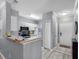 Well-lit kitchen featuring white cabinets, modern appliances, and a breakfast bar with convenient access to dining area at 18001 Richmond Place Dr # 126, Tampa, FL 33647