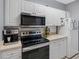 Bright kitchen with stainless steel appliances, white cabinetry, and sleek countertops for a modern cooking experience at 18001 Richmond Place Dr # 126, Tampa, FL 33647