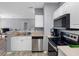 Efficient kitchen featuring stainless steel appliances, a breakfast bar, and light countertops for easy meal preparation at 18001 Richmond Place Dr # 126, Tampa, FL 33647