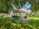 A delightful picnic area is visible with a grill and table under a covered gazebo, surrounded by a lush lawn and trees at 18001 Richmond Place Dr # 126, Tampa, FL 33647