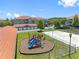 Aerial view of community playground, volleyball court, and building exterior at 18001 Richmond Place Dr # 126, Tampa, FL 33647