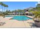 Community pool with palm trees and lounge chairs at 18001 Richmond Place Dr # 126, Tampa, FL 33647