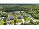 Aerial view showcases a charming single-story home with tropical landscaping in a residential neighborhood at 4146 New Milford St, North Port, FL 34288