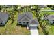 Aerial view of a charming single-story home with tropical landscaping, and an attached two-car garage at 4146 New Milford St, North Port, FL 34288