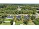 Aerial view of homes surrounded by lush green landscaping in a neighborhood setting at 4146 New Milford St, North Port, FL 34288