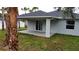 Covered back porch provides ample shade for enjoying this home's outdoor green space at 4146 New Milford St, North Port, FL 34288