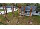 Backyard featuring palm trees, a manicured lawn, and the back of a modern home with a covered patio at 4146 New Milford St, North Port, FL 34288
