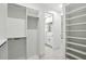 Hallway view of the light and airy bathroom with double vanity and open walk-in closet at 4146 New Milford St, North Port, FL 34288