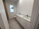 Modern bathroom showcasing a double vanity with sleek countertops and fixtures at 4146 New Milford St, North Port, FL 34288