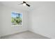 Bright bedroom featuring a ceiling fan, tiled floor and a window with an outdoor view at 4146 New Milford St, North Port, FL 34288