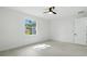 Bright bedroom featuring a ceiling fan, tiled floor and a window with an outdoor view at 4146 New Milford St, North Port, FL 34288