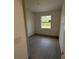 A cozy bedroom featuring tile floors, a window with a view, and modern light switches at 4146 New Milford St, North Port, FL 34288