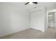 Bright bedroom with a ceiling fan, closet and a door leading to the bathroom at 4146 New Milford St, North Port, FL 34288