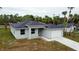 Charming single-story home featuring a neutral color scheme and well-manicured lawn with a two car garage at 4146 New Milford St, North Port, FL 34288