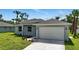 Charming single-story home with a well-manicured lawn, landscaping, and attached two car garage at 4146 New Milford St, North Port, FL 34288