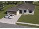 Charming single-story home with a well-maintained lawn and driveway with two parked cars at 4146 New Milford St, North Port, FL 34288