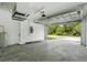 Open garage with high ceiling, natural light, and view to the outdoors, perfect for storage at 4146 New Milford St, North Port, FL 34288