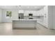 Modern kitchen featuring white cabinetry, stainless steel appliances, and a spacious center island with seating at 4146 New Milford St, North Port, FL 34288